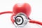 Red stethoscope or phonendoscope with chrome chestpiece carries out survey of heart figure front view. Concept for protection, tre