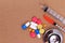 Red stethoscope, syringes and many colorful pills.