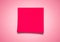 Red sticky Note against neutral pink background