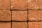 Red stone wall of porous volcanic bricks. rough surface texture