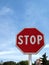 Red Stop Sign alert people under blue sky