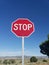 Red stop sign in sky rural country