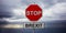 Red stop sign and text BREXIT against dark cloudy sky background. 3d illustration