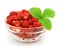 Red strawberry fruits with leafs in glass vase