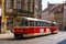 Red streetcar on a cobblestone street in Prague