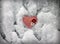 Red striped heart on snow background