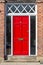 Red stylish front door with the number thirteen