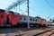 Red suburban train on the station close up. Railway platform with train.