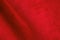 Red suede genuine leather background. Velvet red background close-up photo