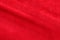 Red suede genuine leather background. Velvet red background close-up photo