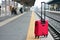 The red suitcase forgotten by the woman at the station