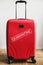 Red suitcase in home with quarantine inscription. Stay home collapse traveling concept