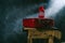 A red suitcase and a red candlestick on a dark background