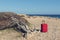 Red suitcase on a rocky sea shore at Cap de ses Salines in Majorca