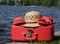 Red suitcase, straw hat, and sandals