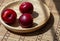 Red summer plums on a wooden and bamboo napkin