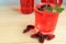 Red summer refreshing, fresh summer drinks with ice cubes, mint and fresh organic mulberries on wooden table.