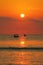 Red sun orange ocean sunset with fisherman boats silhouettes, Kuta beach, Bali, Indonesia