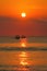 Red sun orange ocean sunset with fisherman boats silhouettes, Kuta beach, Bali, Indonesia