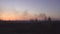 Red sun in smoke sunset on the background of the city after a forest fire and dry grass, copy space, damage