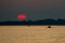 Red Sun at Sunset at Sea with Fishing Boat