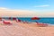 Red sunloungers and parasols at the beach