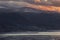 Red sunset clouds over snow covered Snowdonia hills