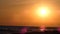 Red sunsets over sea video 4K. The sun touches horizon. Red sky, yellow sun and amazing sea. Summer sunset seascape