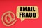 On a red surface, a symbol and a sign with the inscription - Email Fraud