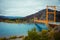 Red suspension bridge over the water runoff of General Carrera Lake, near Lake Bertrand, Puerto Tranquilo, Chile Chico, Aysen,