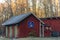 Red Swedish house with information sign highway