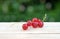 Red sweet currant berry on wooden table, summer harvest