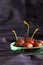 Red sweetheart cherries (grown in England) in a rustic glass bowl on a blue silk background with copy space. Selective focus.