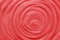 Red swirl cream texture. Moisturizing cosmetic cream abstract background