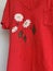 Red t shirt with painted blooming daisies flowers