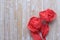 Red table paper napkin roses on bamboo tabletop