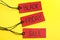 Red tags with words BLACK FRIDAY SALE on yellow background