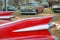 The red tail fin of an old junked vehicle.