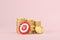 Red target and arrows with stacks coins on pink background. Business finance target investment goals, Marketing time and Targeting