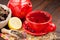 Red tea cup and teapot, healing herbs and lemon