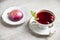 Red tea hibiscus in a vintage cup, antique spoon, cake, raspberry. Copy space