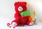 Red teddy bear holding a forgive me note