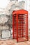 Red telephone box front brick wall block.