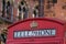 Red Telephone Box in London in front of St Pancras Hotel.