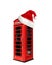 Red telephone box in London isolated on white background and with Santa Claus hat