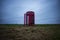 A red telephone box in the middle of nowhere