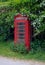 Red telephone box. Peeling paint.