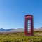 Red telephone box at a remote location