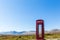 Red telephone box at a remote location