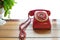 Red telephone vintage old style on table